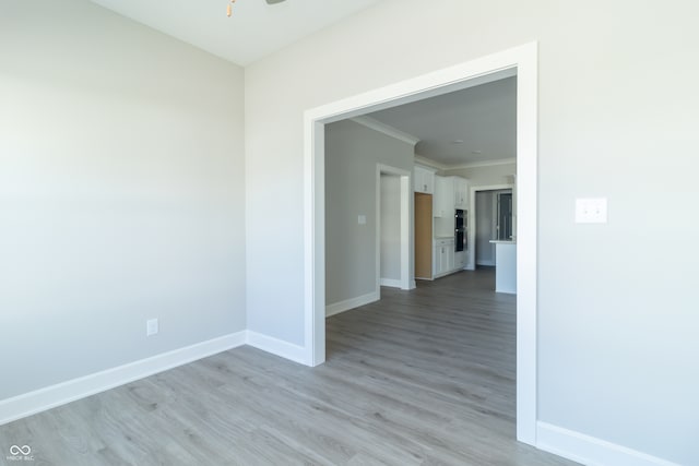 unfurnished room featuring light hardwood / wood-style flooring and ornamental molding