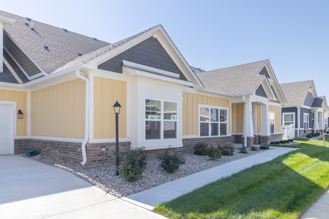 4435 W Preserve Pass, New Palestine, IN 46163 - view of side of home with board and batten siding, a shingled roof, and driveway