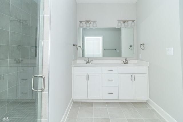 bathroom with vanity, tile patterned floors, and a shower with shower door