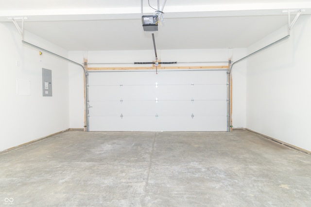 garage featuring electric panel and a garage door opener