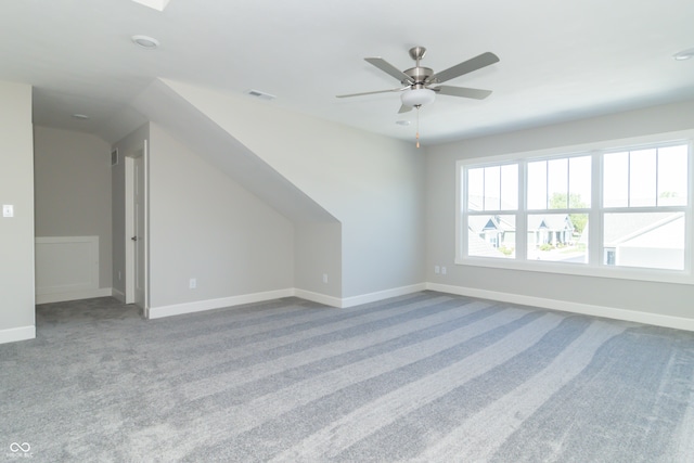 bonus room with carpet flooring and ceiling fan