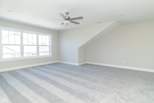 bonus room featuring ceiling fan and carpet