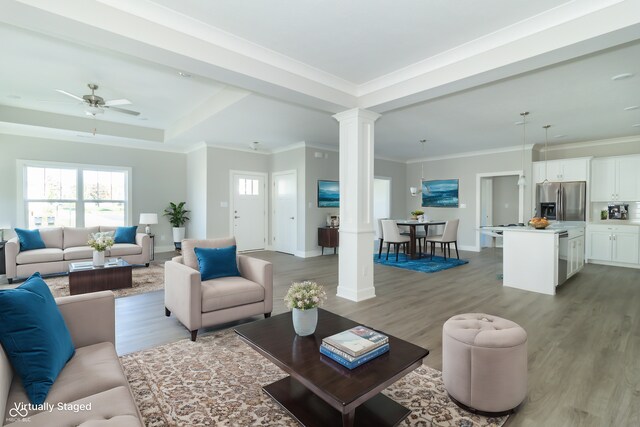 4435 W Preserve Pass, New Palestine, IN 46163 - living area featuring ornate columns, light wood-style flooring, ceiling fan, baseboards, and ornamental molding