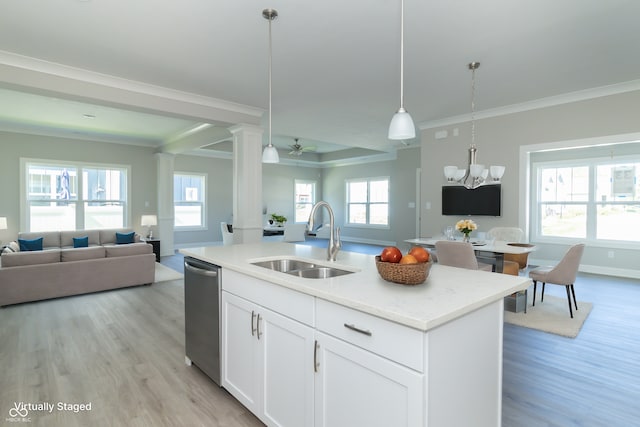 kitchen featuring light wood-type flooring, ceiling fan with notable chandelier, sink, a center island with sink, and white cabinets