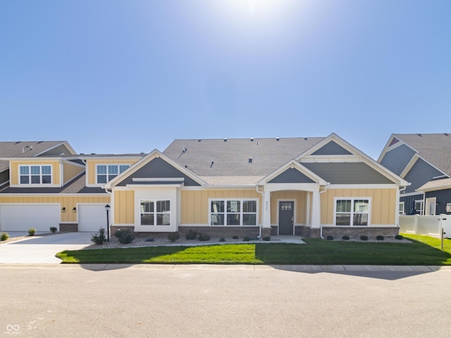 view of front of home with a garage and a front lawn