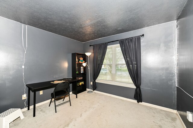 carpeted home office featuring a textured ceiling and baseboards