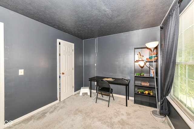 carpeted office space with baseboards and a textured ceiling