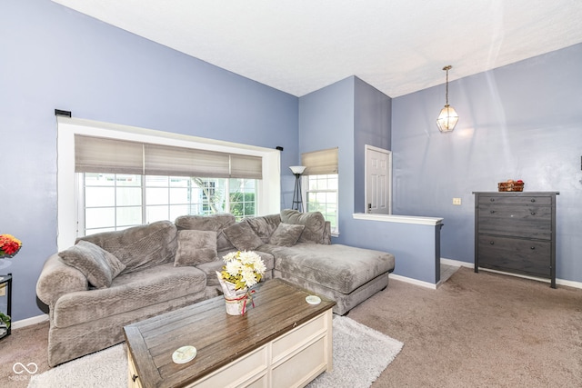 living room featuring carpet and baseboards