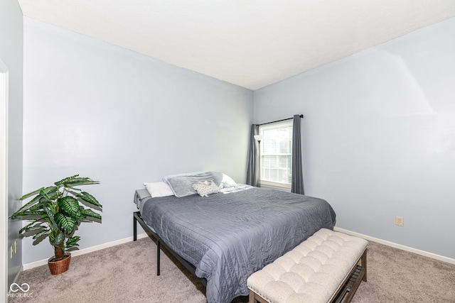 bedroom featuring light colored carpet and baseboards