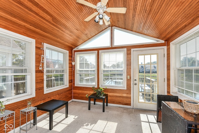 sunroom / solarium with wooden walls, ceiling fan, plenty of natural light, and wooden ceiling