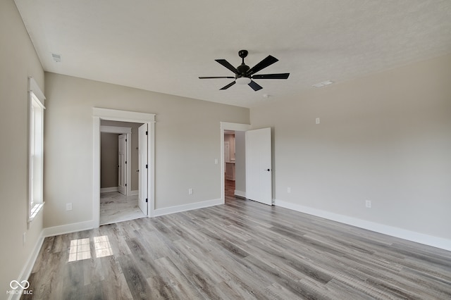 spare room featuring ceiling fan and light hardwood / wood-style flooring