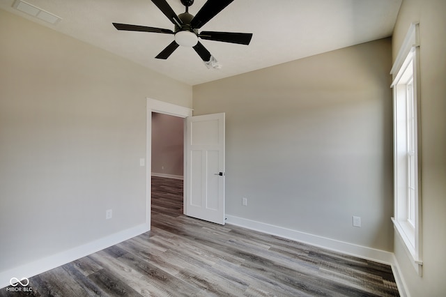 empty room with ceiling fan and light hardwood / wood-style floors