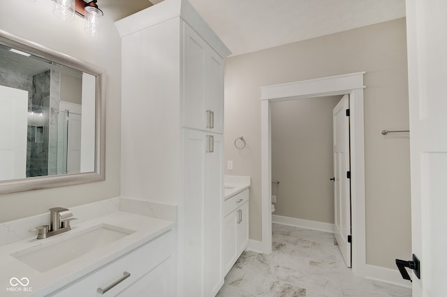 bathroom with vanity, toilet, and an enclosed shower