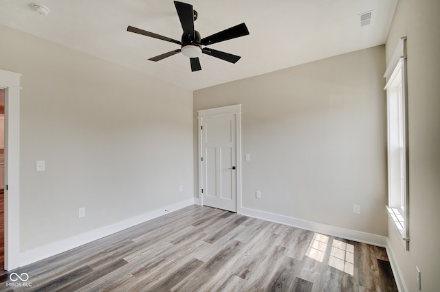 empty room featuring ceiling fan and light hardwood / wood-style floors