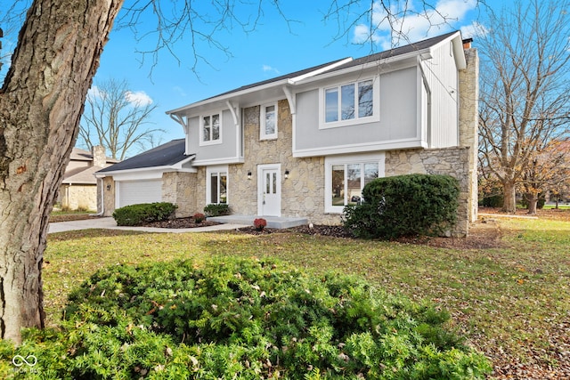 view of front of house featuring a front yard and a garage