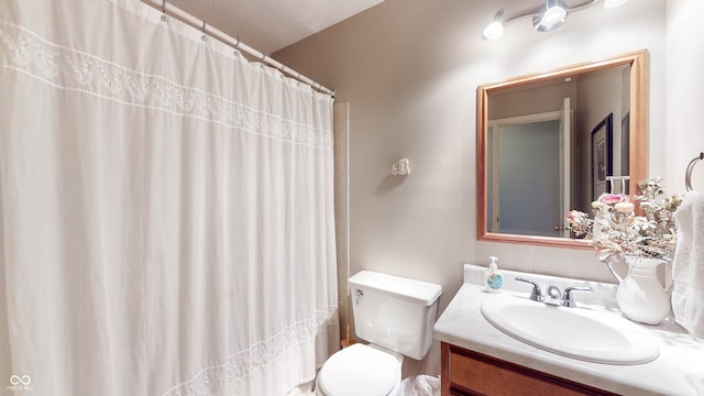 bathroom with vanity, a shower with curtain, and toilet