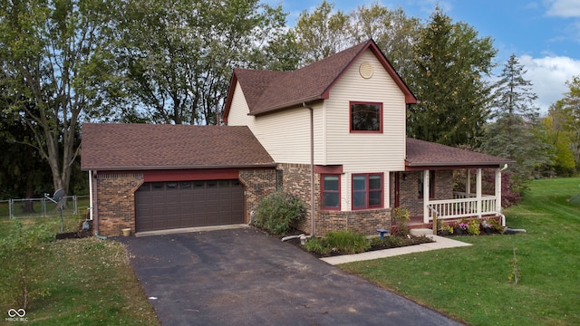 view of front facade with a garage, a front yard, and covered porch