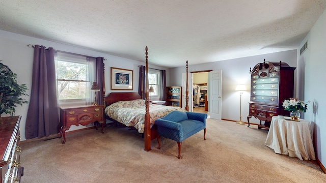 carpeted bedroom featuring a textured ceiling