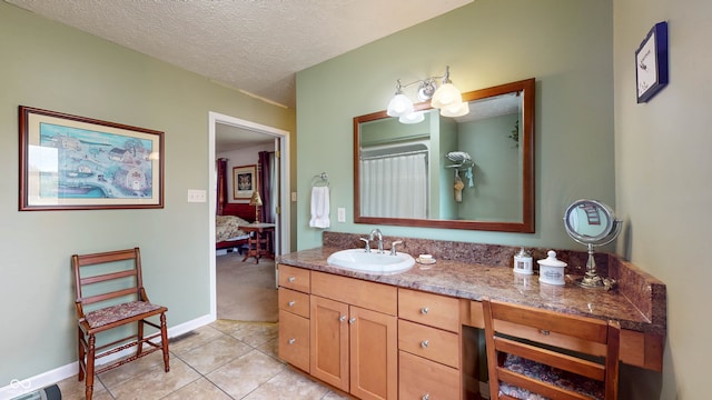 bathroom featuring vanity, tile patterned floors, and a textured ceiling