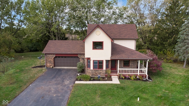 view of front of property featuring a garage, covered porch, and a front lawn