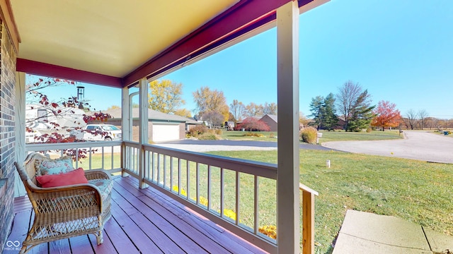 wooden deck with a yard and covered porch