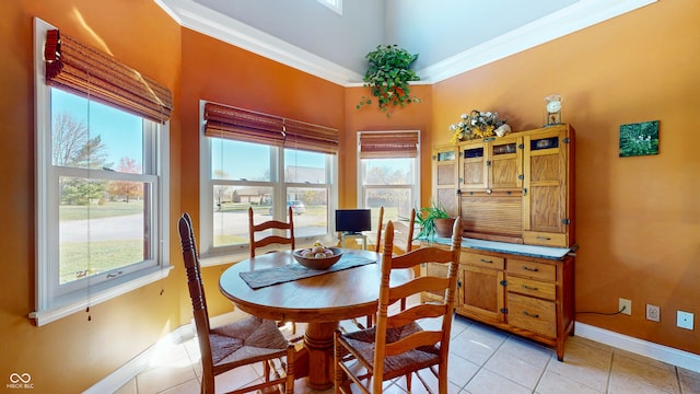 dining room with light tile patterned floors, a wealth of natural light, and ornamental molding