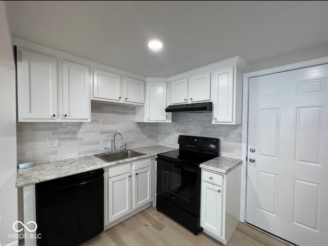 kitchen featuring white cabinets, sink, tasteful backsplash, light hardwood / wood-style flooring, and black appliances