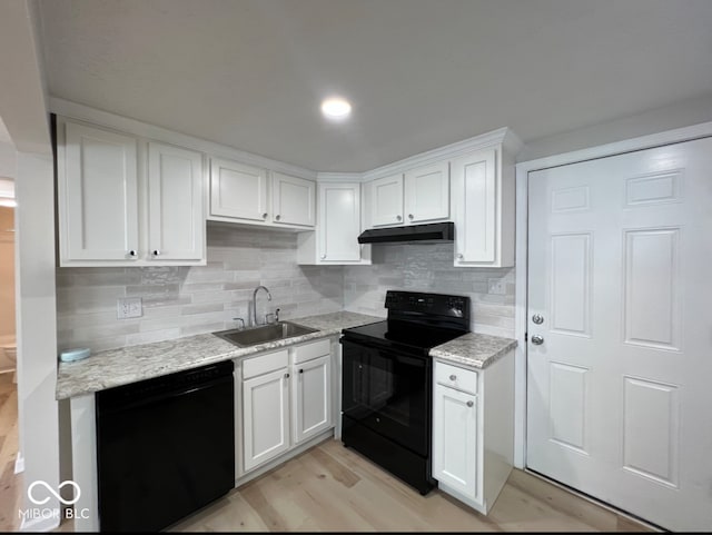 kitchen with light hardwood / wood-style flooring, black appliances, sink, and white cabinetry