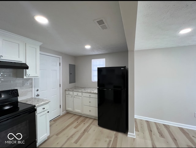 kitchen with light wood-type flooring, white cabinetry, decorative backsplash, and black appliances