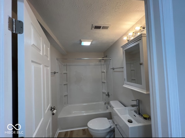 full bathroom with vanity, toilet, a textured ceiling,  shower combination, and hardwood / wood-style floors