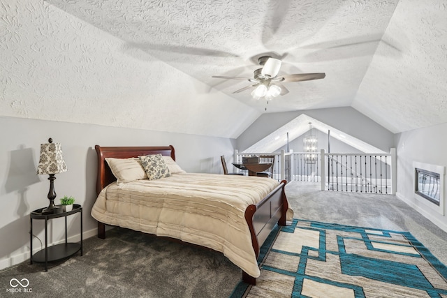 bedroom with vaulted ceiling, dark colored carpet, a textured ceiling, and ceiling fan