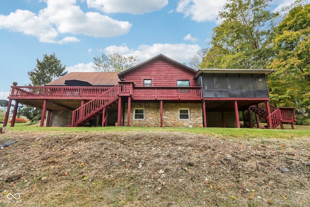 rear view of house with a deck and a sunroom