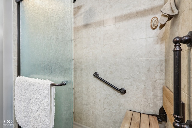 bathroom featuring a shower with door