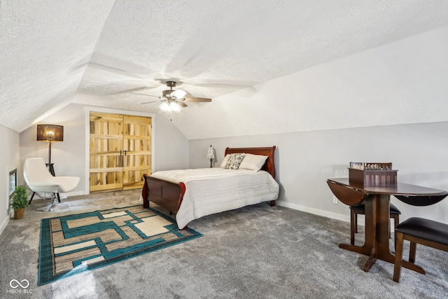 carpeted bedroom with ceiling fan, a textured ceiling, and vaulted ceiling