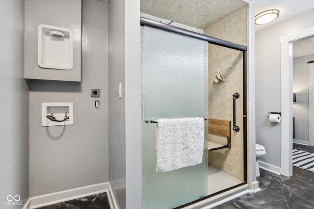 bathroom with a shower with door and toilet