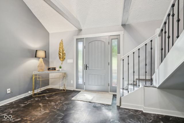 entrance foyer featuring lofted ceiling and a textured ceiling