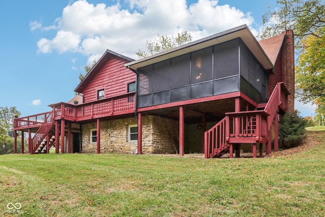 rear view of house featuring a wooden deck, a sunroom, and a lawn