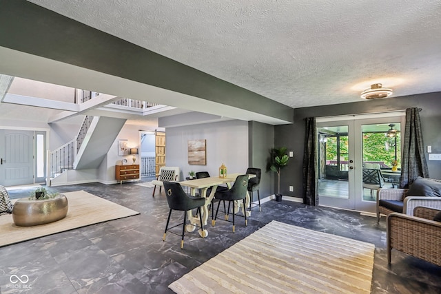 dining room with french doors and a textured ceiling