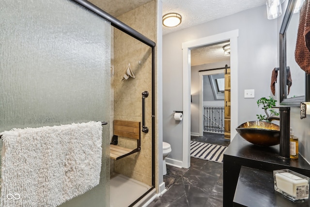 bathroom with a shower with door, sink, a textured ceiling, and toilet