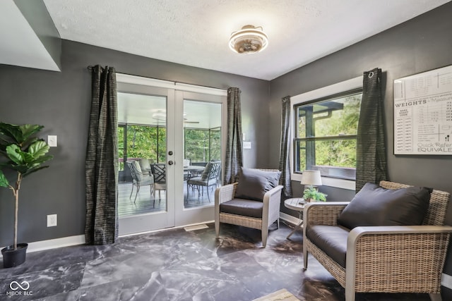 sitting room with french doors and a textured ceiling