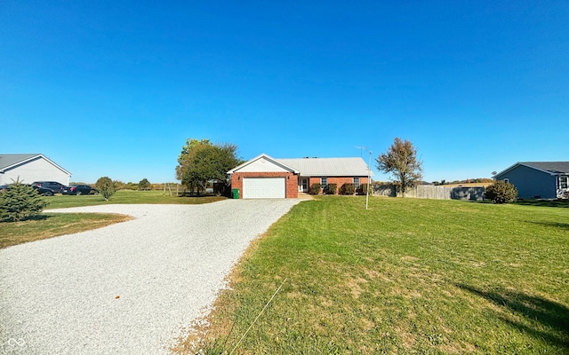 ranch-style house featuring a front lawn and a garage