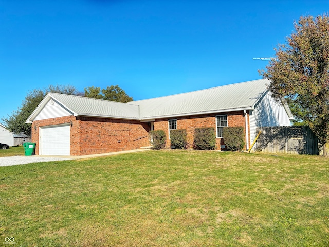 ranch-style house featuring a front lawn and a garage