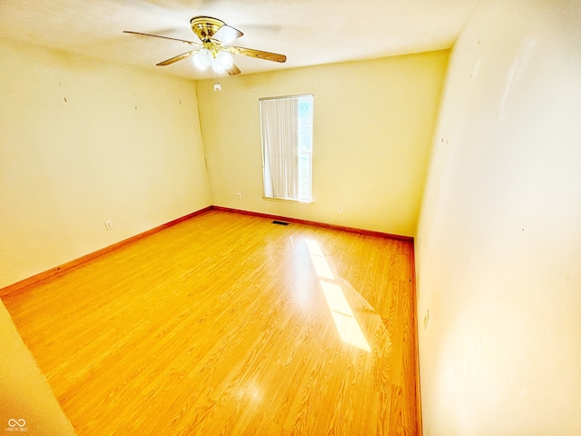 empty room featuring hardwood / wood-style floors and ceiling fan