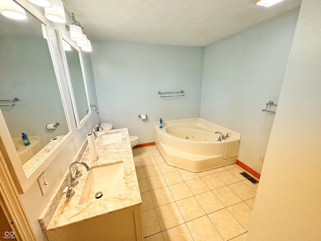 bathroom with a textured ceiling, toilet, a washtub, vanity, and tile patterned floors