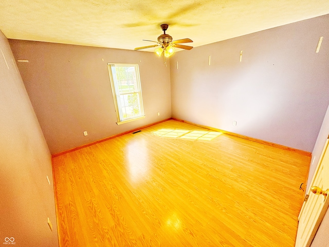 spare room featuring hardwood / wood-style floors and ceiling fan