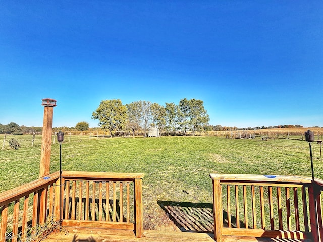 view of yard with a wooden deck and a rural view