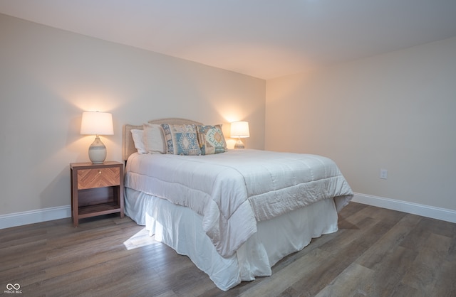 bedroom with dark hardwood / wood-style flooring