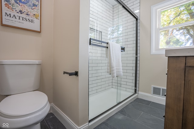 bathroom featuring toilet and an enclosed shower