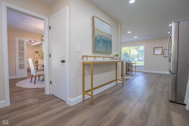 corridor with hardwood / wood-style floors