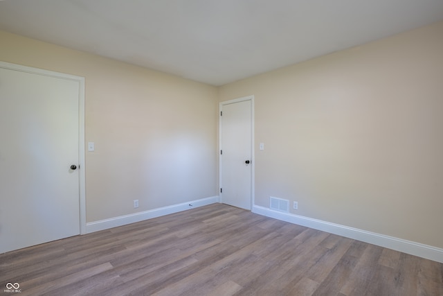 unfurnished room with light wood-type flooring